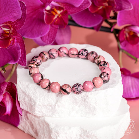 Rhodonite bracelet of forgiveness from Conscious Items, featuring polished pink stones on a subtle stretch bracelet.