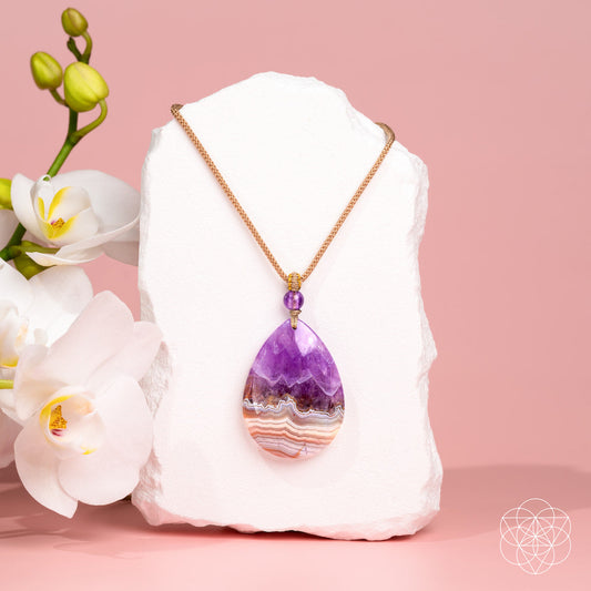 Amethyst Crazy Lace Agate pendant from Conscious Items with intricate purple and beige stone details on a silver chain.