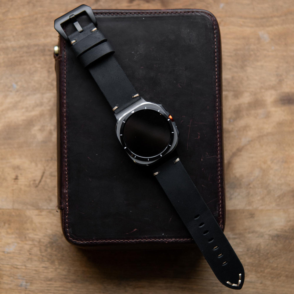 Robust Leather Strap R01 for Samsung Galaxy Watch Ultra, showing a close-up of the brown leather band with stitching detail.