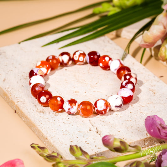 Feminine Force Carnelian Orca Agate bracelet by Conscious Items featuring polished orange and black patterned stone beads.