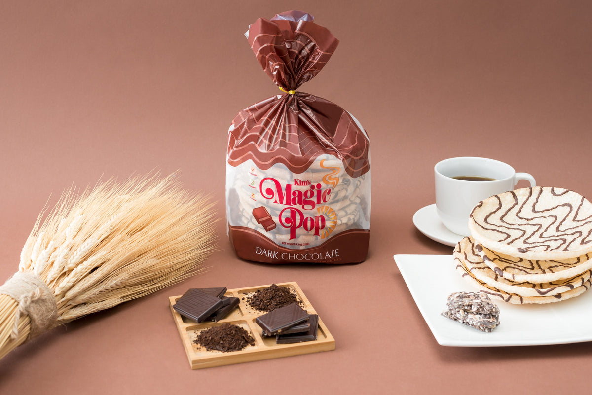 Kim's Magic Pop dark chocolate-flavored snack with drizzled dark chocolate, showcasing its crispy, caramelized surface and rich chocolate topping.