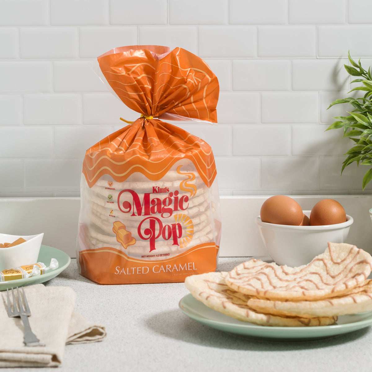 Kim's Magic Pop salted caramel flavored popcorn drizzled with caramel, in a clear bowl, ready to enjoy.