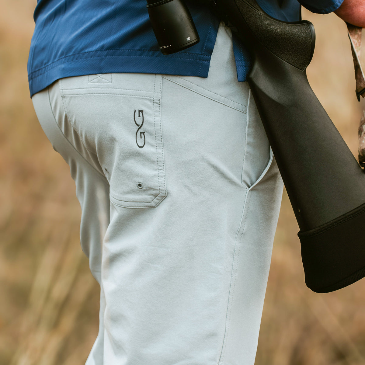 GameGuard Tarpon SeaDrift Pants displayed on a model, featuring lightweight, waterproof fishing pants with adjustable waist and reinforced knees.