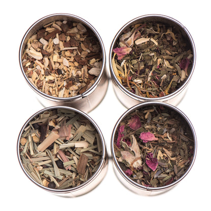 Herbal tea stack with assorted Ayurvedic teas from Paavani Ayurveda Skincare and Wellness, featuring colorful tea boxes and herbs.
