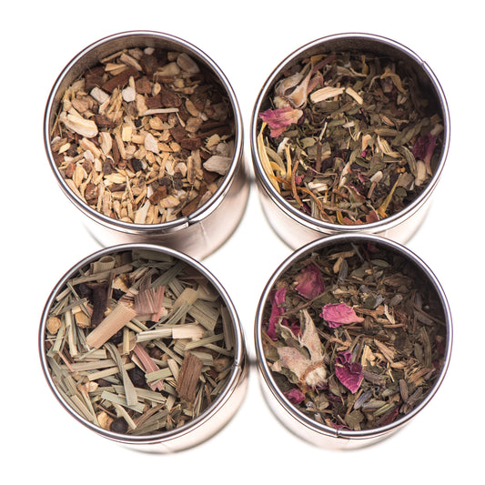 Herbal tea stack with assorted Ayurvedic teas from Paavani Ayurveda Skincare and Wellness, featuring colorful tea boxes and herbs.