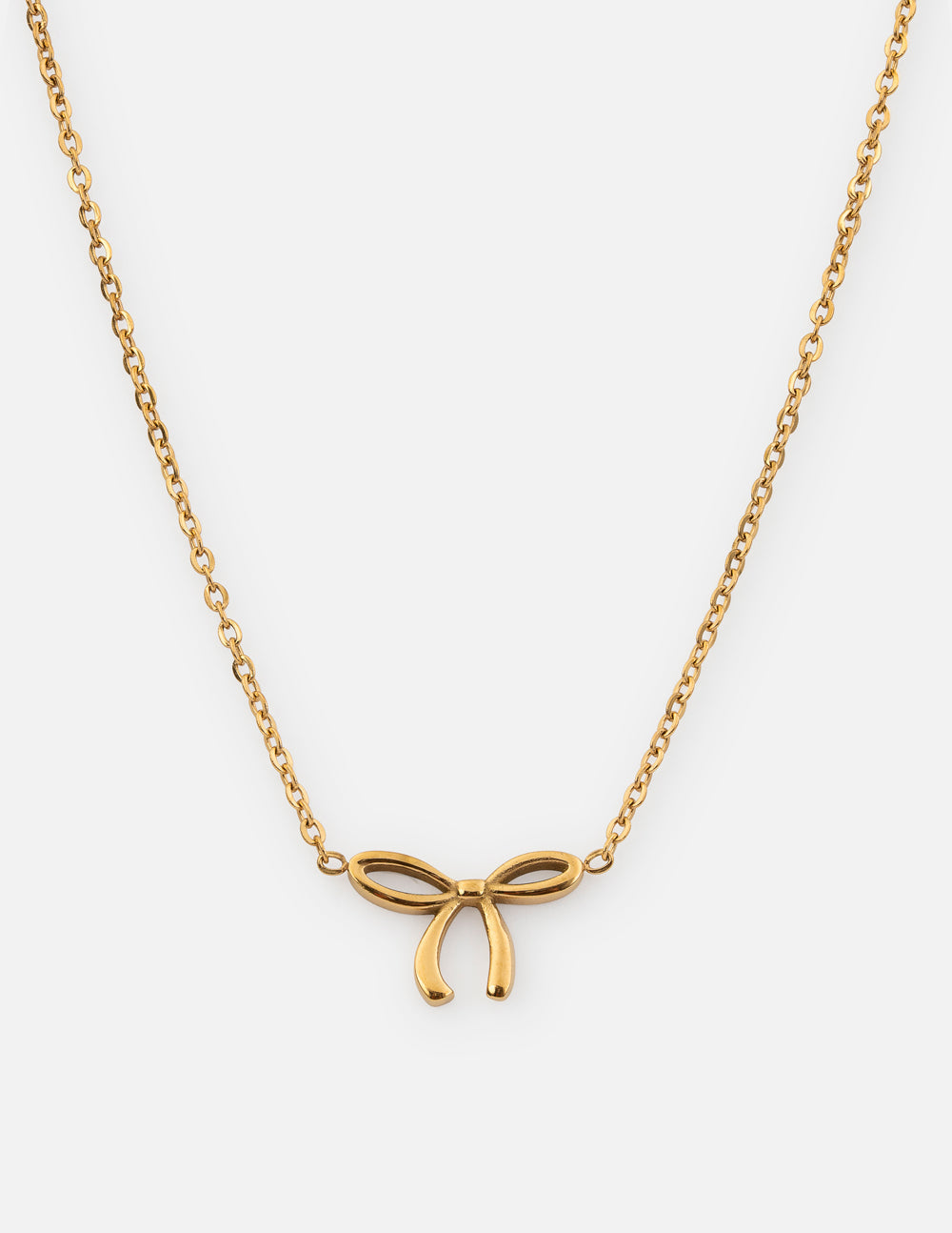 Dainty bow necklace by Elevated Faith featuring a delicate gold chain and small bow pendant.