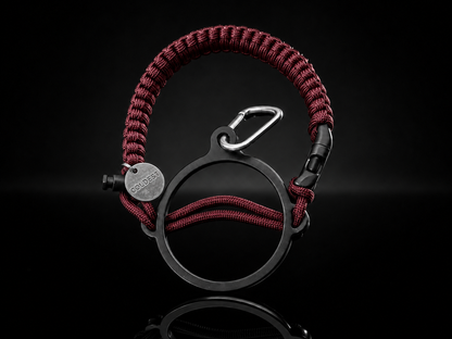 Dark pink and black Coldest Paracord Handle accessory with durable woven design on a dark background.