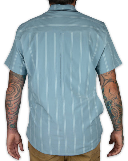 Mid blue short sleeve shirt from Off The Grid Surplus with a casual fit and classic collar, shown on a hanger.