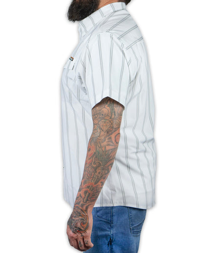 White short sleeve Daryll SS shirt by Off The Grid Surplus displayed on a hanger, showcasing its clean design and fabric texture.