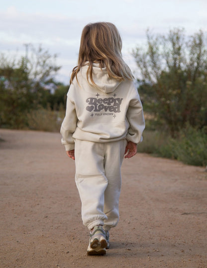 Brightly colored kids hoodie from Elevated Faith featuring "Deeply Loved" design, soft fabric, and comfortable fit for children.