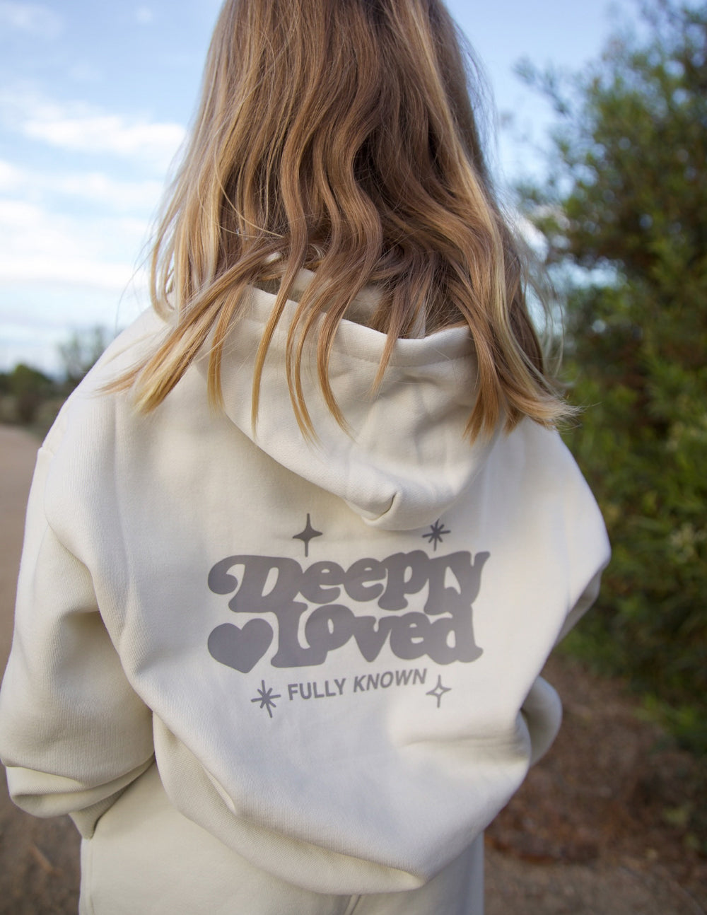 Brightly colored kids hoodie from Elevated Faith featuring "Deeply Loved" design, soft fabric, and comfortable fit for children.