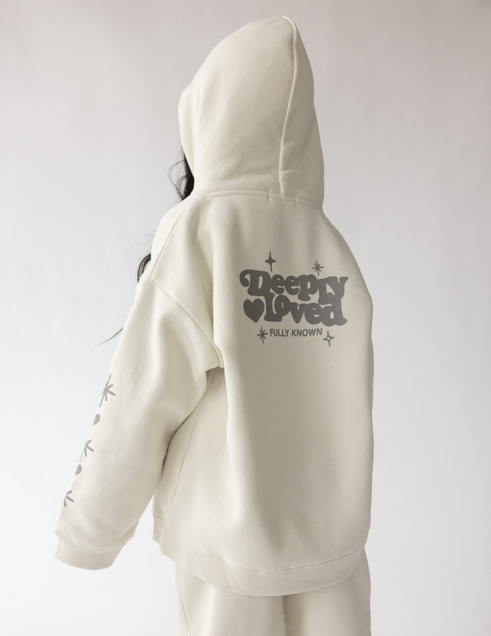 Kids hoodie by Elevated Faith featuring "Deeply Loved" text, soft fabric, and comfortable fit for children.