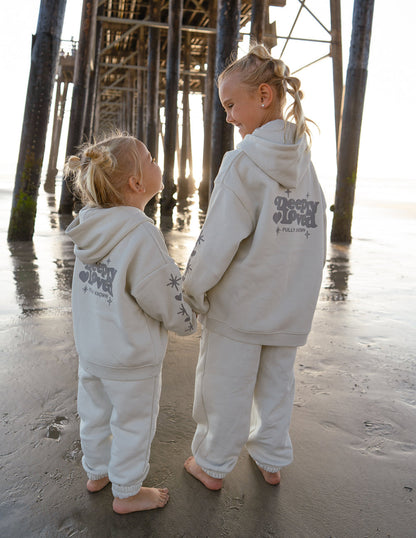 Kids hoodie by Elevated Faith featuring "Deeply Loved" design, made from soft fabric for comfortable wear.