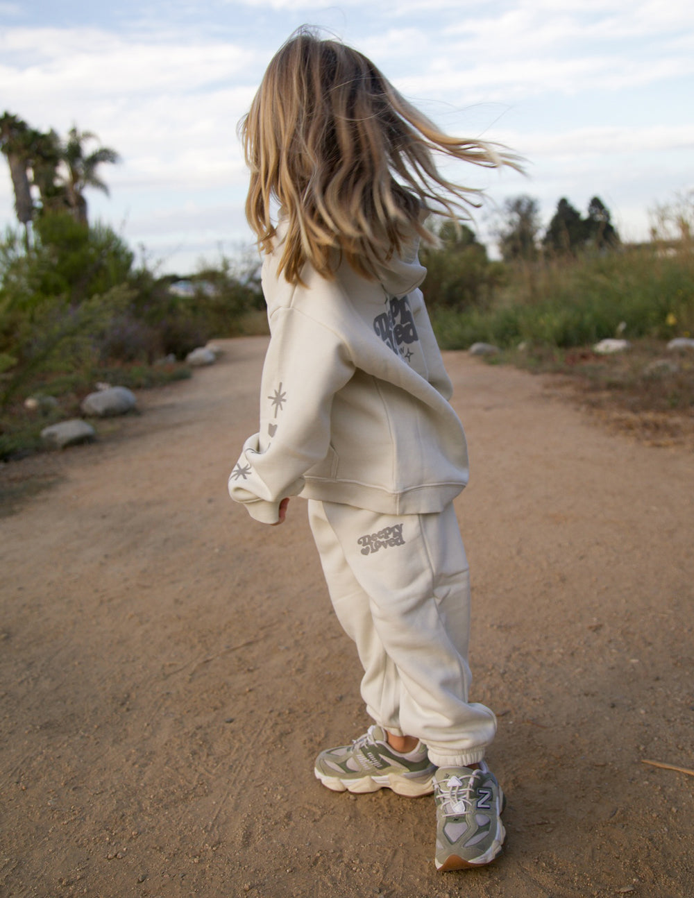 Kids sweatpant by Elevated Faith in a cozy, navy blue design with "Deeply Loved" printed on the front for children.