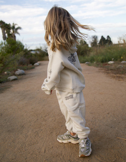 Kids sweatpant by Elevated Faith in a cozy, navy blue design with "Deeply Loved" printed on the front for children.
