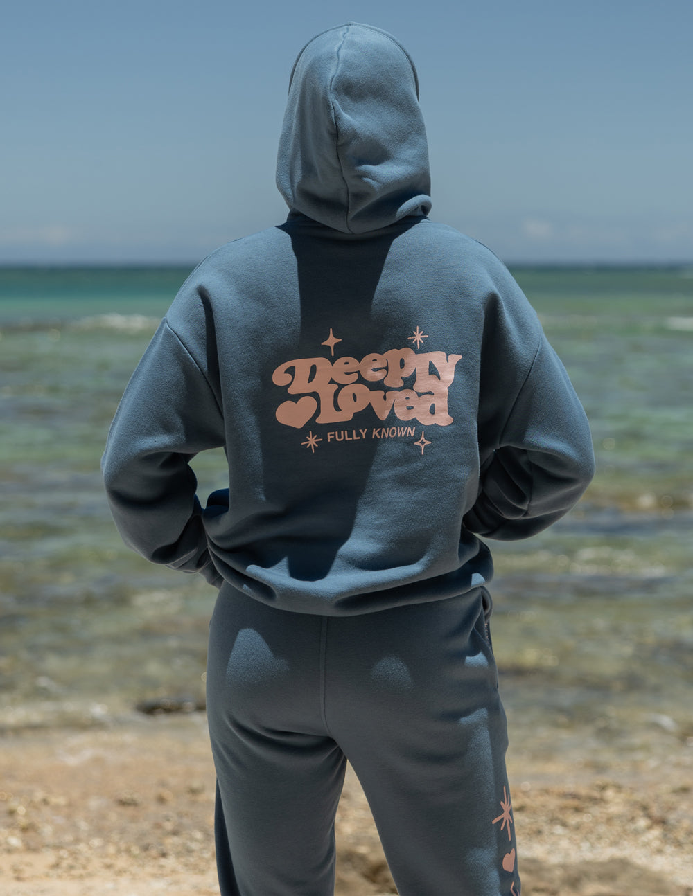 Unisex hoodie from Elevated Faith with "Deeply Loved" design, soft fabric, and comfortable fit, shown in a front view.
