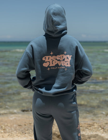 Unisex hoodie from Elevated Faith with "Deeply Loved" design, soft fabric, and comfortable fit, shown in a front view.