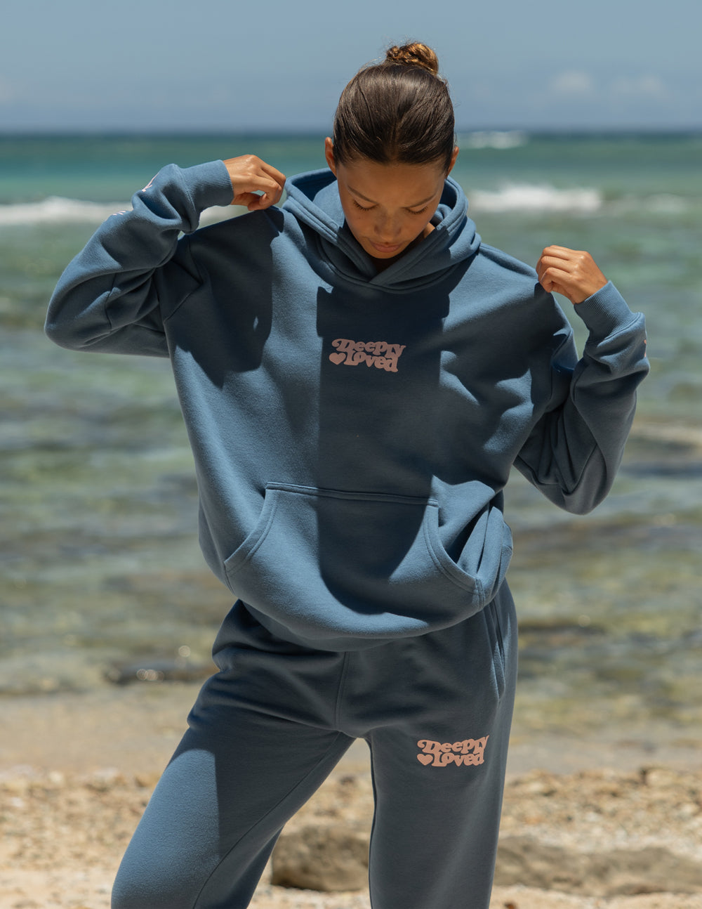 Unisex hoodie by Elevated Faith featuring a Deeply Loved design, soft fabric, and casual fit, shown in a front view.