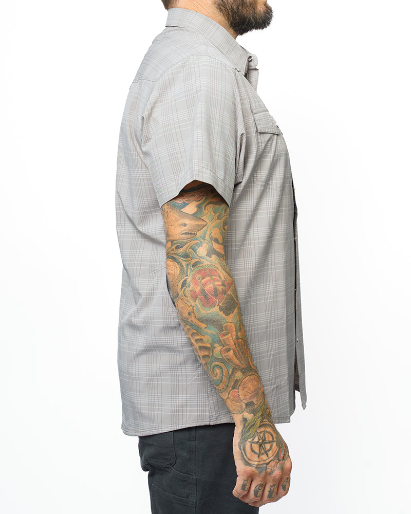 Storm grey Deke SS shirt by Off The Grid Surplus, short sleeve shirt with a casual fit and button front, displayed on a hanger.