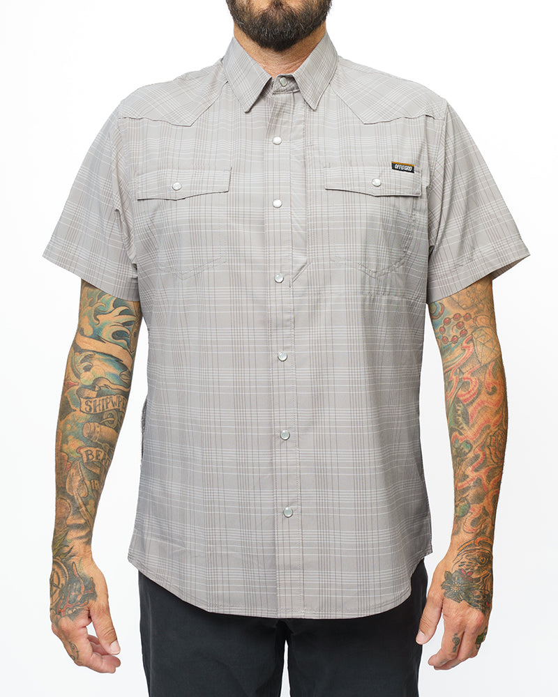 Storm grey Deke SS shirt by Off The Grid Surplus, featuring a short sleeve design and casual fit, displayed on a hanger.
