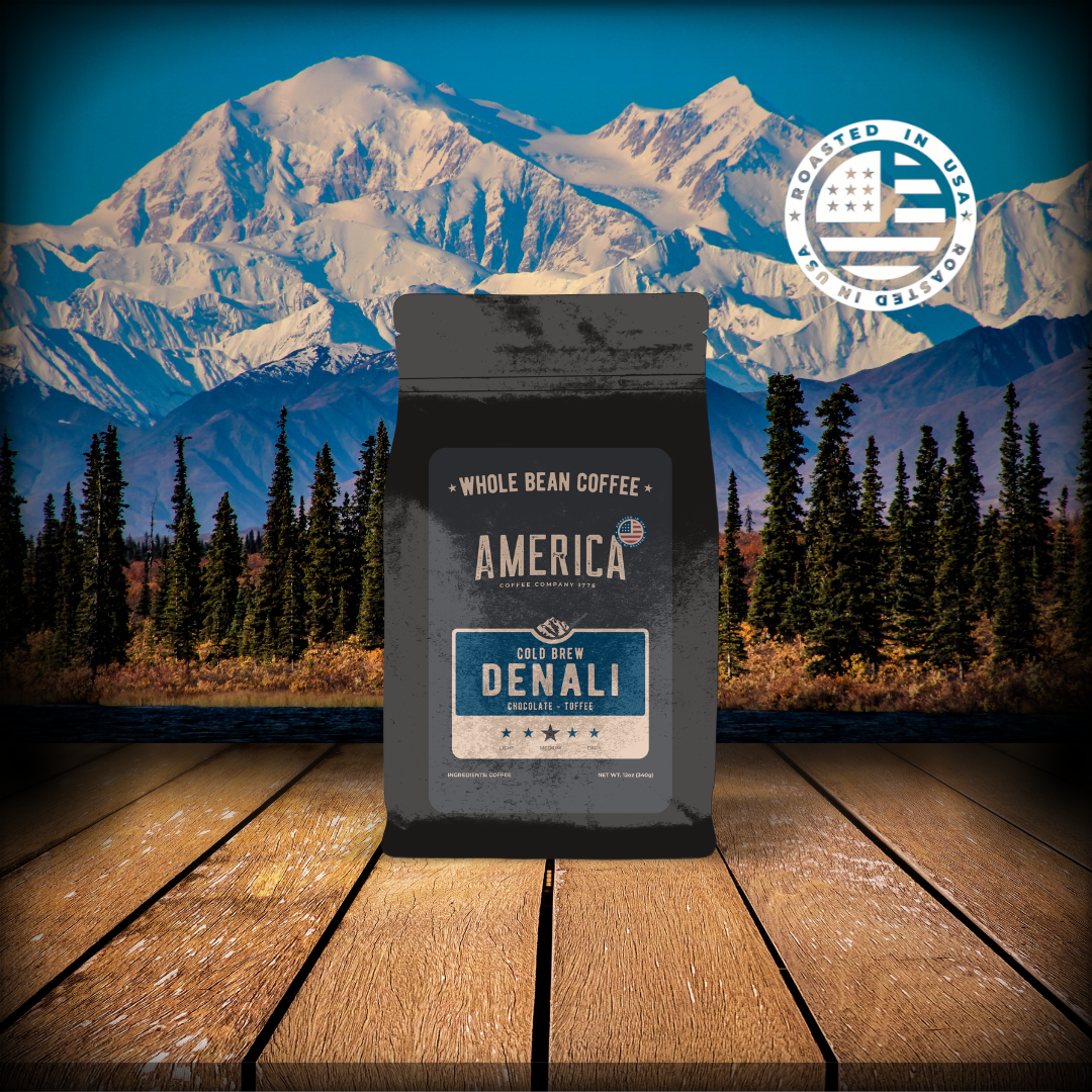 Cold brew coffee in a glass, labeled Denali by America Supply Company LLC, served over ice with a dark, rich appearance.