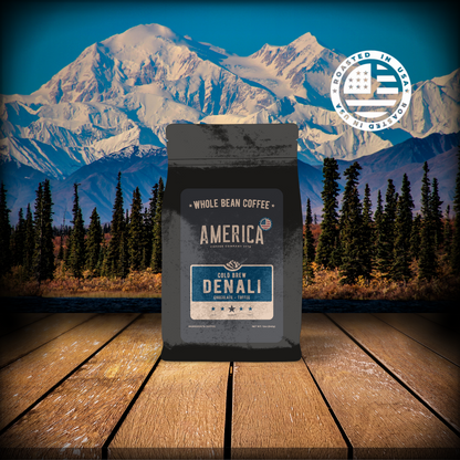 Cold brew coffee in a glass, labeled Denali by America Supply Company LLC, served over ice with a dark, rich appearance.