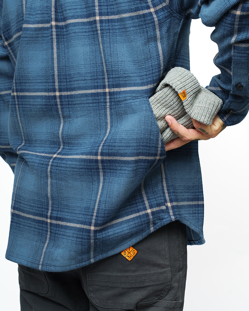 Pale blue Destroyer Flannel shirt by Off The Grid Surplus, showing soft fabric and button-down front on a hanger.