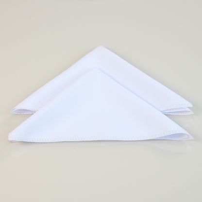 Set of white placemats with gold accents from Maison Charlo, includes table runner, napkins, and napkin rings for elegant table setting.