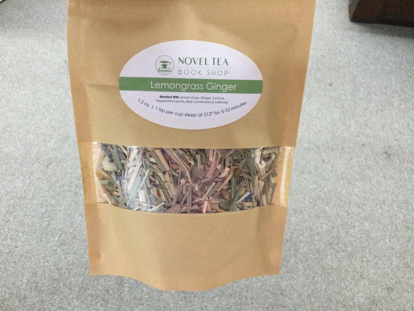 Herbal Lemongrass Ginger Loose Leaf Tea leaves in a clear glass jar, showcasing fresh, aromatic herbal tea ingredients.