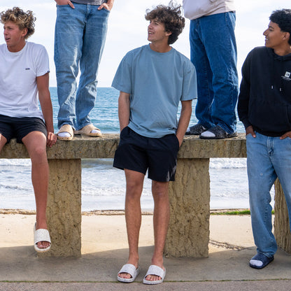Fleks East Beach Slide in cloudy day style, featuring a comfortable slip-on design and casual beach footwear.