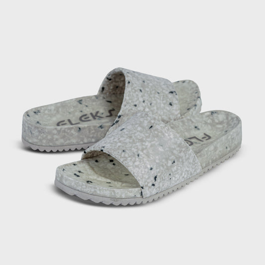 Fleks East Beach Slide in cloudy day color, featuring comfortable slip-on design and casual style, shown on a model.