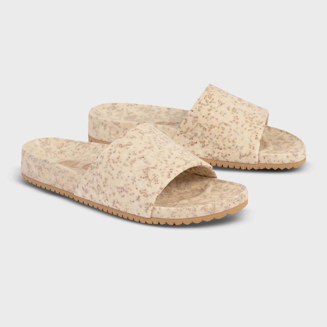 Fleks East Beach Slide in white sand color, featuring casual slip-on design perfect for beachwear and summer outings.
