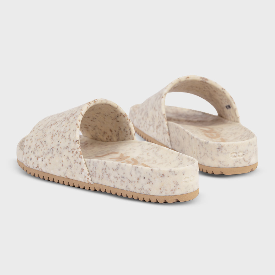 Fleks East Beach Slide in white sand color, showcasing comfortable slip-on footwear with a minimalist design.
