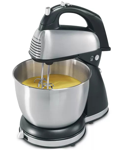 Hamilton Beach 6-speed classic hand and stand mixer with stainless steel beaters and control dial, in a kitchen setting.