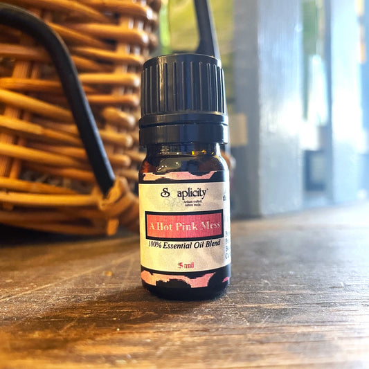 Hot pink Soaplicity Mess essential oil blend in a 5 ml bottle, vibrant color and natural packaging visible.