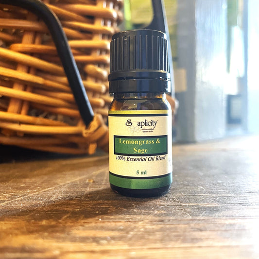 Essential oil blend of lemongrass and sage in a 5 ml bottle from Soaplicity, showing the amber glass container with a white label.