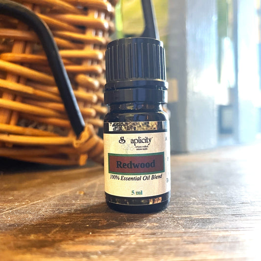 Redwood essential oil blend from Soaplicity in a 5ml bottle, showcasing the amber-colored oil and natural labeling.