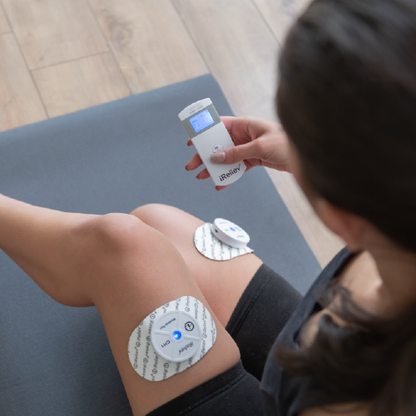 iReliev TENS Unit for pain relief with wearable design, featuring adjustable controls and electrode pads for targeted therapy.