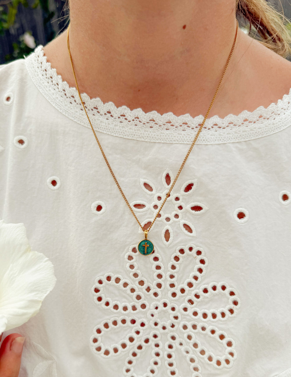 Emerald Agape Cross pendant necklace by Elevated Faith featuring a detailed cross with emerald accents, jewelry on a chain.