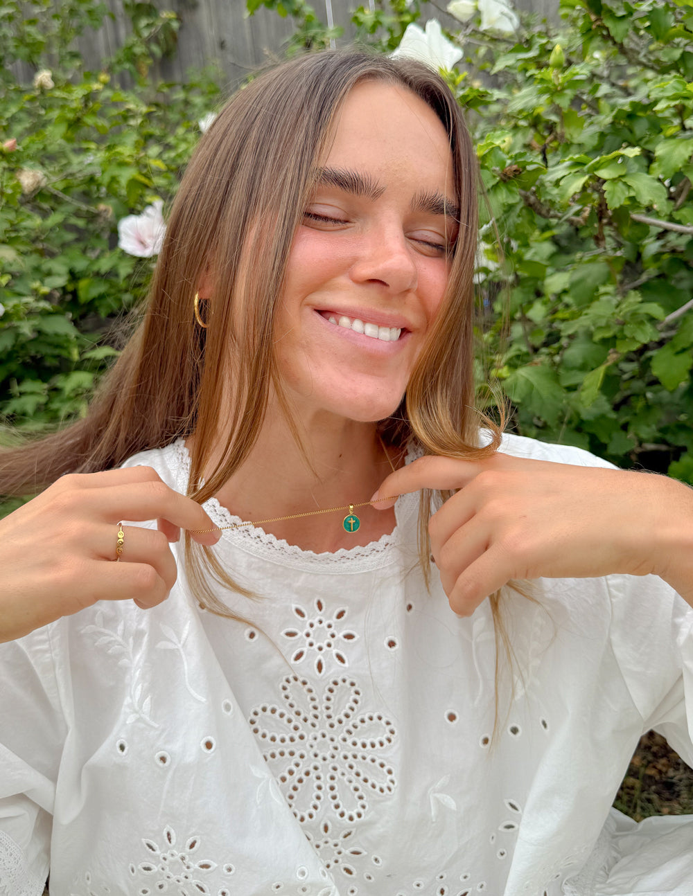 Emerald Agape Cross pendant necklace by Elevated Faith featuring a detailed cross design with green emerald accents.