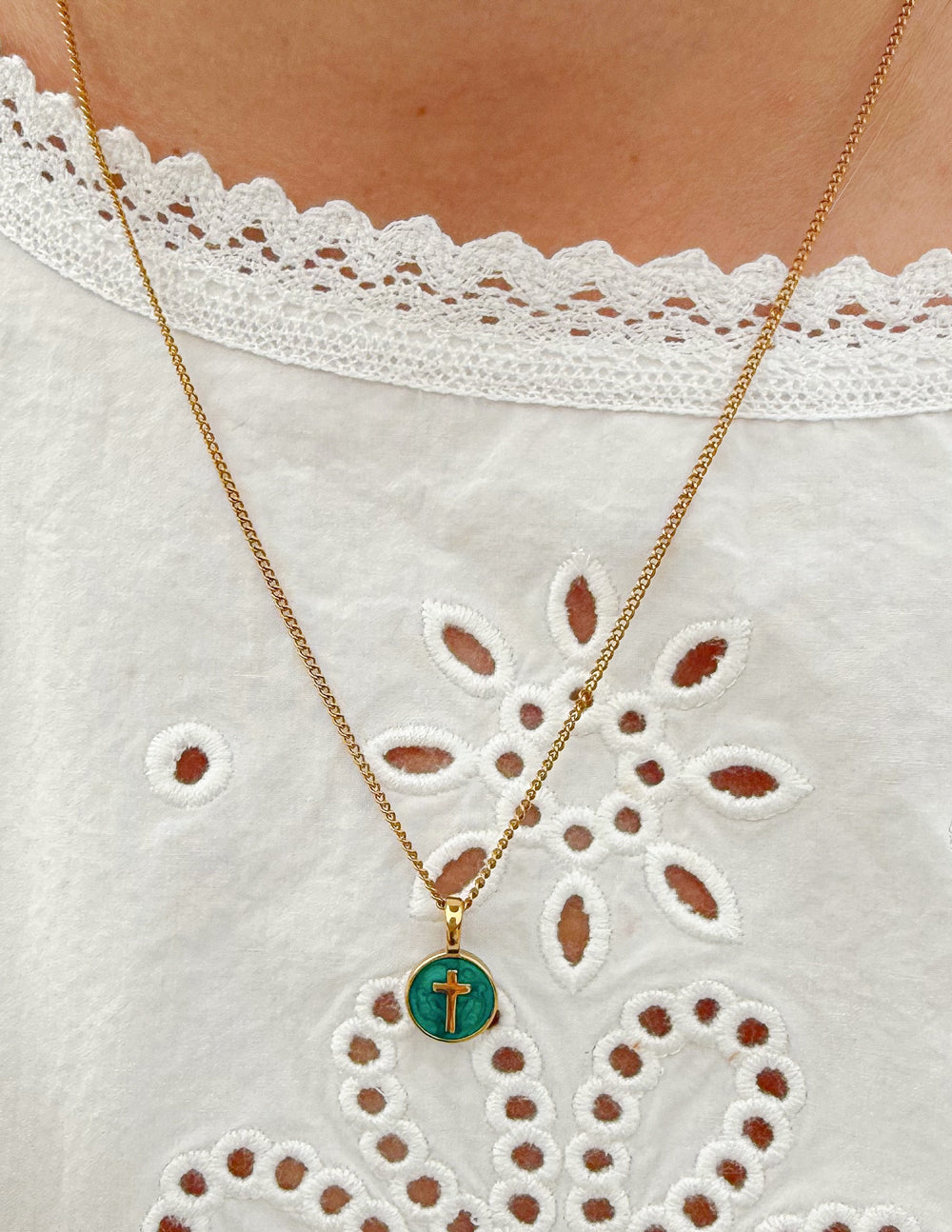 Emerald Agape Cross pendant necklace by Elevated Faith featuring a green gemstone cross on a chain.