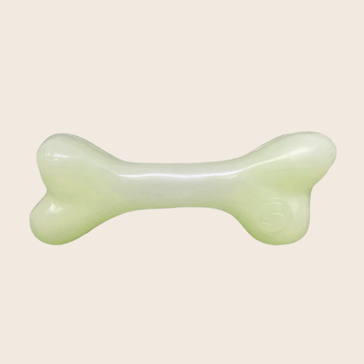 Farm To Pet glow-in-the-dark dog treat dispenser shaped like a bone for dispensing treats and chews during playtime.