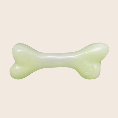 Farm To Pet glow-in-the-dark dog treat dispenser shaped like a bone for dispensing treats and chews during playtime.