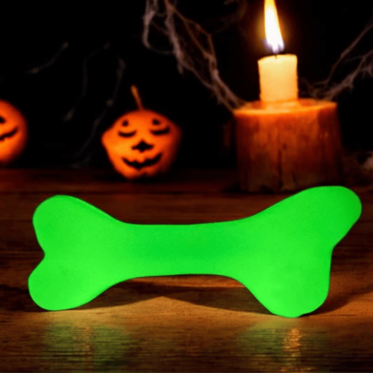 Farm To Pet glow-in-the-dark dog treat dispenser shaped like a bone and pumpkin, designed for interactive pet play and training.