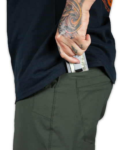 Dark army green Off The Grid Surplus field shorts with multiple pockets and durable fabric, designed for outdoor wear.