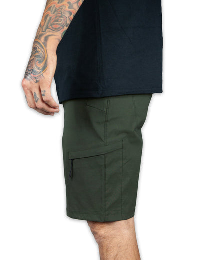 Dark army green Off The Grid Surplus field shorts with multiple pockets and rugged fabric, designed for outdoor activities.