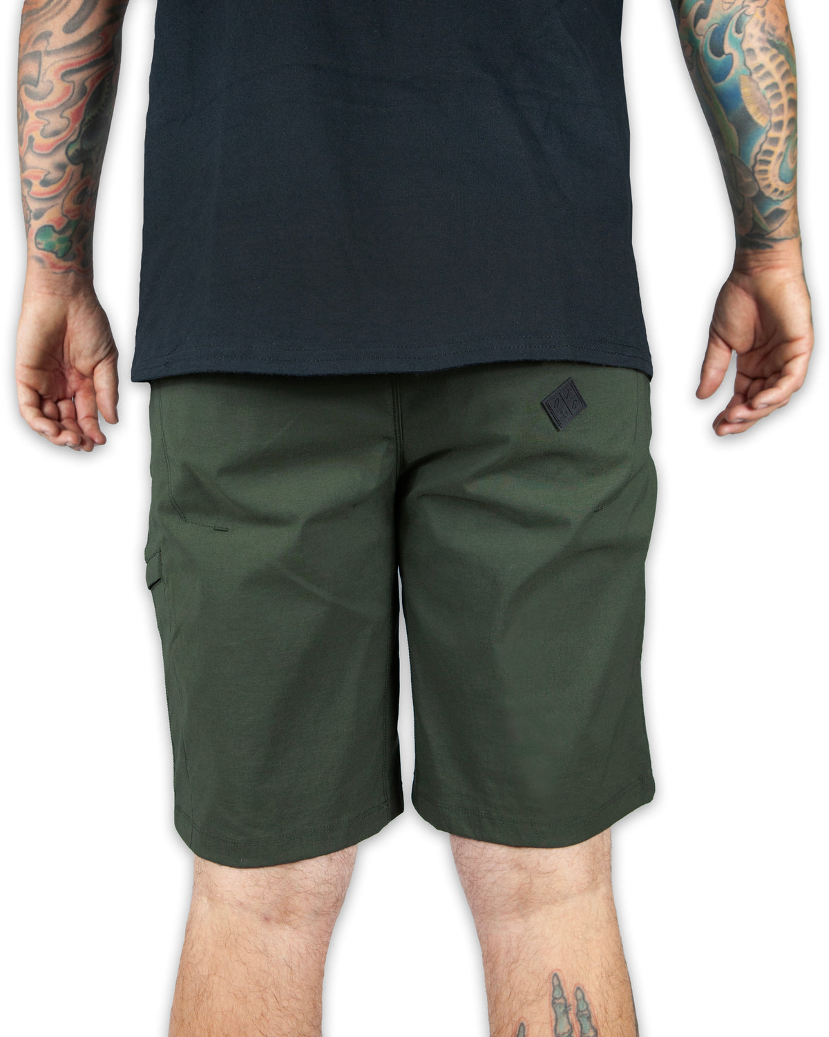 Dark army green Off The Grid Surplus field shorts with multiple pockets and rugged fabric, suitable for outdoor activities.