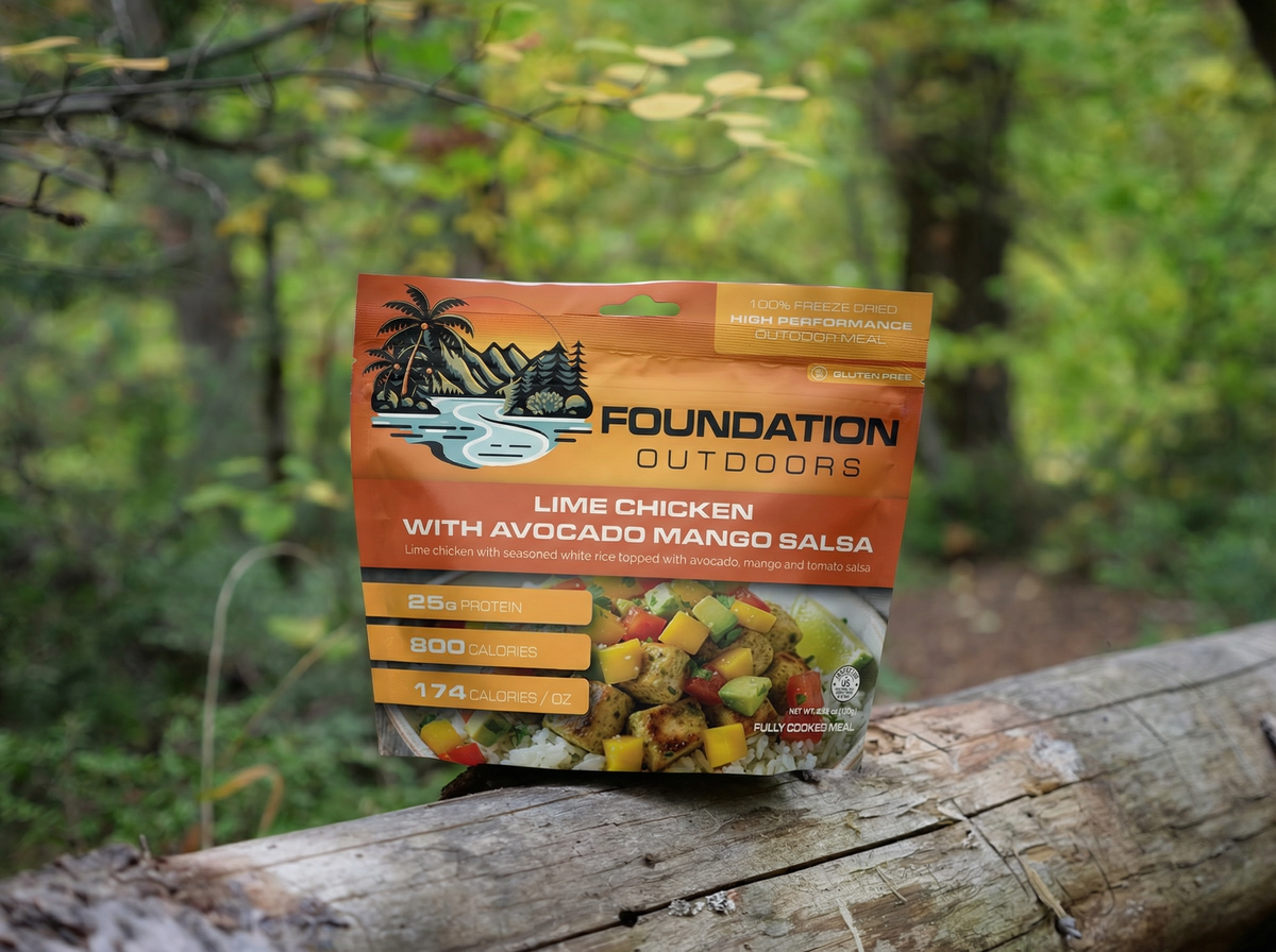 Grilled lime chicken with sliced avocado and mango salsa served on a plate, healthy meal from FOUNDATION Outdoors.