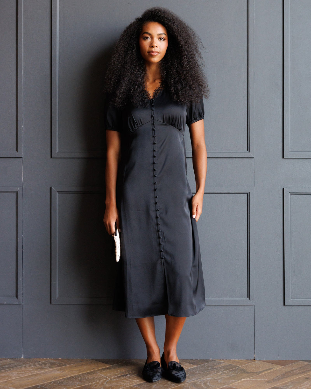 Downeast First Love Dress displayed on a hanger, showcasing its elegant design and fabric details.