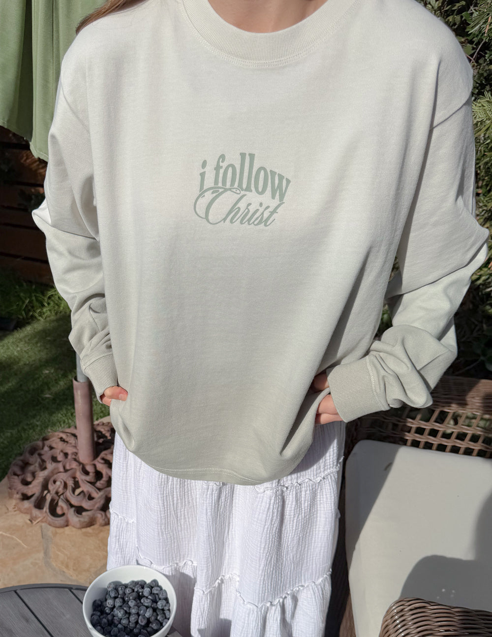 Black heavyweight T-shirt from Elevated Faith with "Follow Christ" printed design, long sleeve, casual fit.